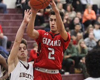 William D. Lewis The vindicator  Girard's Austin Claussell(2) shoots over Liberty's Kevin Hawn(3) during February 7, 2017 action at Liberty.