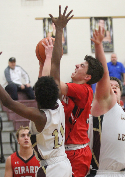 William D. Lewis The vindicator  Girard's Austin O'Hara(33) shoots over Liberty's Dan Banks(11) and Derek Gilcher(20) during Feb 7, 2017 action at Liberty.