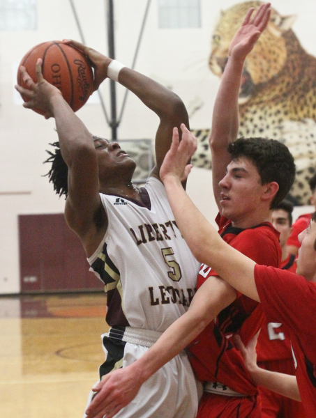 William D. Lewis The vindicator  Liberty's Dra rushton(5) shoots over girard's Austin O'Hara(33) during Feb 7, 2017 action at Liberty.