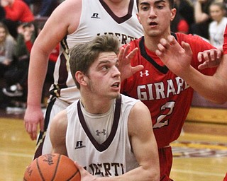 William D. Lewis The vindicator  Liberty's Kevin Hawn(3) drives around Girard's Austin claussell(2)during Feb 7, 2017 action at Liberty. In background is Liberty'sDerek Gilcher (20)