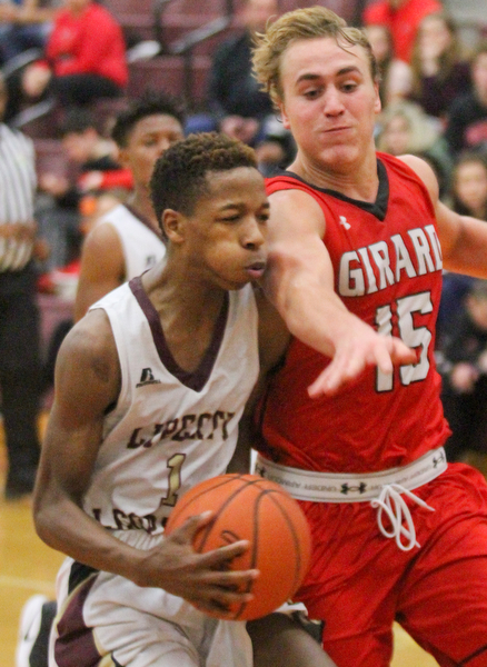 William D. Lewis The vindicator Liberty's Andre Bowers(1) drives around  giard's Mark Haid(15)during Feb 7, 2017 action at Liberty.