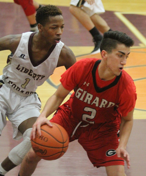 William D. Lewis The vindicator  Girard's Austin Claussell(2) drives past  Liberty's Andre Bowers(1) during Feb 7, 2017 action at Liberty.