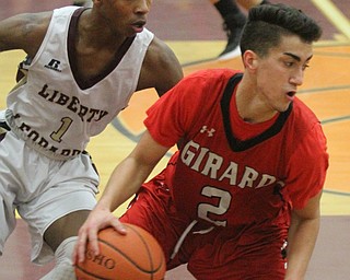 William D. Lewis The vindicator  Girard's Austin Claussell(2) drives past  Liberty's Andre Bowers(1) during Feb 7, 2017 action at Liberty.