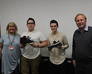 Neighbors | Abby Slanker.Canfield High School students Andrew Murphy and Justin Schneider (center) were named winners of the Best Presentation by judges Vicki McGee (left) and Jack Scott (right). The duo, also known as EZ Way, Inc., pitched their product, EZ Carrying Case, during Sherry Creighton’s Introduction to Business Course on Jan. 6.
