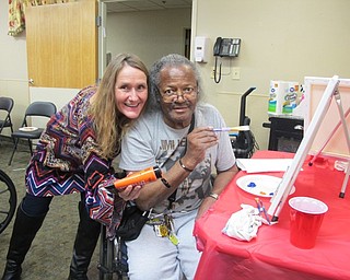 Neighbors | Alexis Bartolomucci.Maureen McCarty gave Beeghly Oaks resident Herald more paint for his snowman painting during the Paint and Taste event on Jan. 13.