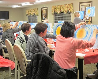 Neighbors | Alexis Bartolomucci.Guests at Beeghly Oaks painted the backgrounds for their snowman paintings on Jan. 13 during the Paint and Taste.