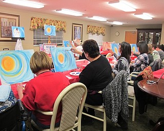 Neighbors | Alexis Bartolomucci.Guests worked on their snowman paintings at the Beeghly Oaks Paint and Taste event on Jan. 13 for the residents, families and other community members.