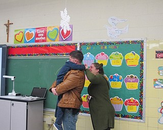 Neighbors | Alexis Bartolomucci.Jason and Jana Davis embraced their son, Jason Davis Jr., after his dad surprises him at St. Christine School on Jan. 24.