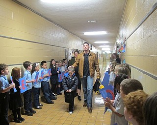 Neighbors | Alexis Bartolomucci.Jason, Jana and Jason Davis Jr. walked down the halls of St. Christine School on Jan. 24  as students held up signs after Jason surprised his son in class.