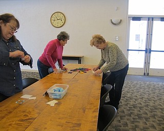Neighbors | Alexis Bartolomucci.Guests used craft scissors and glue to decorate and put together the hot chocolate holder on Jan. 27 during the paper craft program at the Austintown library.