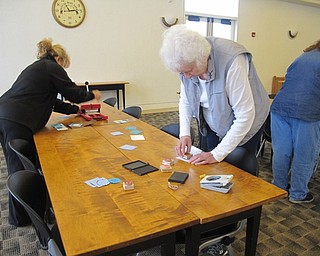 Neighbors | Alexis Bartolomucci.The guests at the Austintown library paper craft program used stamps to decorate the paper for their hot chocolate holders on Jan. 27.