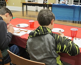 Neighbors | Alexis Bartolomucci.Two of the children concentrate on painting in their fox drawing during the painting program at the Poland library on Jan. 23.