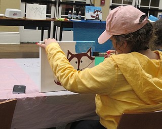 Neighbors | Alexis Bartolomucci.One of the children at the painting program at the Poland library on Jan. 23 paints the background for her fox painting.