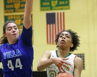 William D Lewis The vindicator Ursuline's Simone Comer(32) drives past Villa MAria'sSydney Palermo(44)  during  Feb 9, 2017 game at Ursuline.