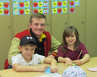 Neighbors | Submitted.A St. Charles alumni from Cardinal Mooney works with current St. Charles students.