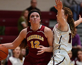 CANFIELD, OHIO - FEBRUARY 9, 2017: Taylor Martin #12 of Mooney drives down the baseline on Rachel Maynard #12 of South Range during the first half of their game Thursday night at South Range High School. DAVID DERMER | THE VINDICATOR