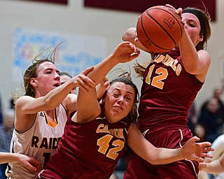 CANFIELD, OHIO - FEBRUARY 9, 2017: Taylor Martin #12 of Mooney grabs a rebound away from teammate Conchetta Rinazdi #42 and Rachel Maynard #12 of South Range during the first half of their game Thursday night at South Range High School. DAVID DERMER | THE VINDICATOR