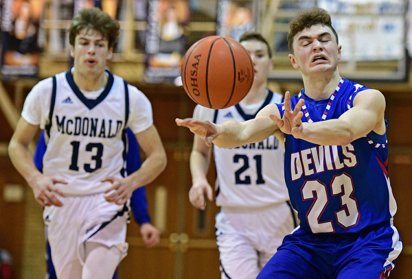 McDONALD, OHIO - FEBRUARY 10, 2017: Cole DeZee #23 of Western Reserve passes the ball up court while being chased by Joey Ragazzine #21 and Dylan Portolese #13 of McDonald during the first half of their game Friday night at Western Reserve High School. DAVID DERMER | THE VINDICATOR