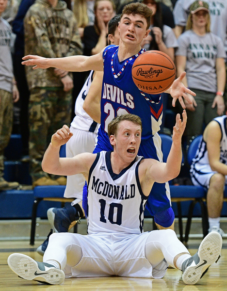 McDONALD, OHIO - FEBRUARY 10, 2017: Evan Magil #10 of McDonald locates the ball while on his backside while being pressured from behind by Cole DeZee #23 of Western Reserve during the first half of their game Friday night at Western Reserve High School. DAVID DERMER | THE VINDICATOR