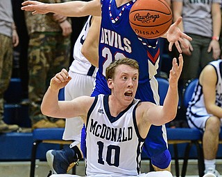 McDONALD, OHIO - FEBRUARY 10, 2017: Evan Magil #10 of McDonald locates the ball while on his backside while being pressured from behind by Cole DeZee #23 of Western Reserve during the first half of their game Friday night at Western Reserve High School. DAVID DERMER | THE VINDICATOR