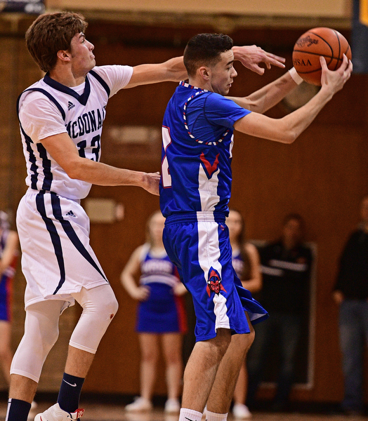 McDONALD, OHIO - FEBRUARY 10, 2017: Dom Velasquez #2 of Western Reserve catches the in bounds pass near the sideline while being pressured by Dylan Portolese #13 of McDonald during the first half of their game Friday night at Western Reserve High School. DAVID DERMER | THE VINDICATOR