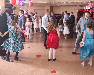 (from left) Chris and Audrey(9) Solveski, Clint and Maddie(9) Page and Rich and Gina(9) Romeo at the Daddy and Daughter Princess Dance at Lariccia Family Community Center in Boardman Park in Boardman on Saturday, Feb. 11, 2017. ..(Nikos Frazier | The Vindicator)..