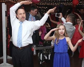 Bob Zupanek and daughter, Sarah(12) spell out YMCA at the Daddy and Daughter Princess Dance at Lariccia Family Community Center in Boardman Park in Boardman on Saturday, Feb. 11, 2017. ..(Nikos Frazier | The Vindicator)..