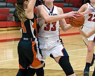 MICHAEL G TAYLOR | THE VINDICATOR- 02-11-17  -Basketball-  1st qtr., Fitch's #33 Sabria Hunter drives  against Howland's #4 Mackenzie Maze for the score. Lady Basketball- Howland Tigers vs Austintown Fitch Falcons at Austintown Fitch High School, Austintown, OH