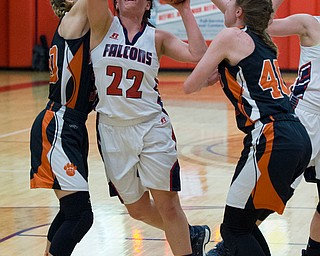 MICHAEL G TAYLOR | THE VINDICATOR- 02-11-17  -Basketball-  1st qtr., Fitch's #22 Natalie Lynn is fouled as she drives to the hoop against Howland's #40 Kayla Clark (right) and #30 Alex Ochman. Lady Basketball- Howland Tigers vs Austintown Fitch Falcons at Austintown Fitch High School, Austintown, OH