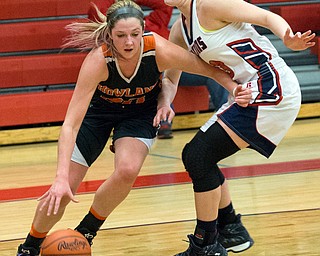 MICHAEL G TAYLOR | THE VINDICATOR- 02-11-17  -Basketball-  4th qtr., Howland's #20 Sara Price drives past Fitch's #33 Sabria Hunter for the score. Lady Basketball- Howland Tigers vs Austintown Fitch Falcons at Austintown Fitch High School, Austintown, OH
