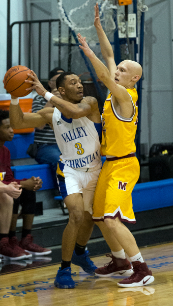 MICHAEL G TAYLOR | THE VINDICATOR- 02-11-17  -Basketball-  1st qtr., Mooney's #12 John Mikos applies the defense to YVC #4 Elijah Anderson. Cardinal Mooney vs Youngstown Valley Christian Eagles at Youngstown Valley Christian High School, Youngstown, OH.