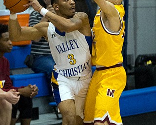 MICHAEL G TAYLOR | THE VINDICATOR- 02-11-17  -Basketball-  1st qtr., Mooney's #12 John Mikos applies the defense to YVC #4 Elijah Anderson. Cardinal Mooney vs Youngstown Valley Christian Eagles at Youngstown Valley Christian High School, Youngstown, OH.