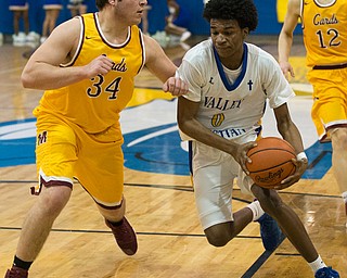 MICHAEL G TAYLOR | THE VINDICATOR- 02-11-17  -Basketball-  3rd qtr., YVC #0 Emmanuel Armour drives to the hoop against Mooney's #34 Vinny Gentile. Cardinal Mooney vs Youngstown Valley Christian Eagles at Youngstown Valley Christian High School, Youngstown, OH.