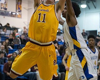 MICHAEL G TAYLOR | THE VINDICATOR- 02-11-17  -Basketball-  3rd qtr.,  Mooney's #11 Anthony Fire drives to the hoop against YVC #0 Emmanuel Armour. Cardinal Mooney vs Youngstown Valley Christian Eagles at Youngstown Valley Christian High School, Youngstown, OH.