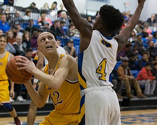 MICHAEL G TAYLOR | THE VINDICATOR- 02-11-17  -Basketball-  3rd qtr., Mooney's #12 John Mikos scores over YVC #4 Jamynk Jackson. Cardinal Mooney vs Youngstown Valley Christian Eagles at Youngstown Valley Christian High School, Youngstown, OH.