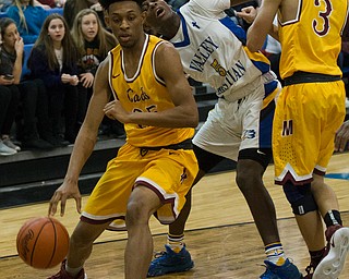 MICHAEL G TAYLOR | THE VINDICATOR- 02-11-17  -Basketball-  3rd qtr., Mooney's #3 Alex Wollet sets a pick enabling Mooney's #35 Jordan Stanford to drive by YVC #5 Milan Square. Cardinal Mooney vs Youngstown Valley Christian Eagles at Youngstown Valley Christian High School, Youngstown, OH.