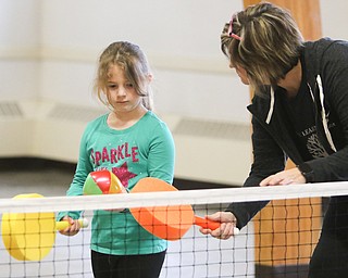        ROBERT K. YOSAY  | THE VINDICATOR..Cindy Hritz teaches Lyndi Rodland  hand technique... Poland Presbyterian  preschool students are using the new tennis equipment the Poland Presbyterian Weekday Preschool got via a US Tennis Association grant..-30-