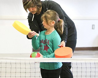        ROBERT K. YOSAY  | THE VINDICATOR..Cindy Hritz teaches Lyndi Rodland  hand technique... Poland Presbyterian  preschool students are using the new tennis equipment the Poland Presbyterian Weekday Preschool got via a US Tennis Association grant..-30-