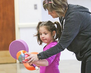        ROBERT K. YOSAY  | THE VINDICATOR..Cindy Hritz teaches  Samantha Sturgiss how to hit the ball across the net...... Poland Presbyterian  preschool students are using the new tennis equipment the Poland Presbyterian Weekday Preschool got via a US Tennis Association grant..-30-