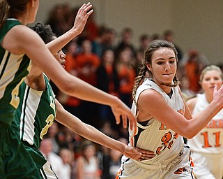 NEWTON FALLS, OHIO - FEBRUARY 13, 2017: Isabelle Kline #33 of Newton Falls carries the ball around Simone Comer #32 of Ursuline during the first half of their game Monday night at Newton Falls High School. DAVID DERMER | THE VINDICATOR