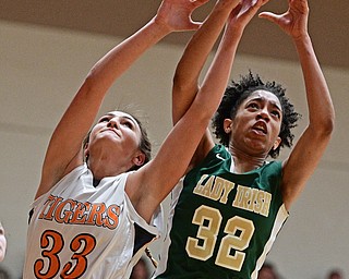 NEWTON FALLS, OHIO - FEBRUARY 13, 2017: Simone Comer #32 of Ursuline and Isabelle Kline #33 of Newton Falls reach for a rebound during the first half of their game Monday night at Newton Falls High School. DAVID DERMER | THE VINDICATOR