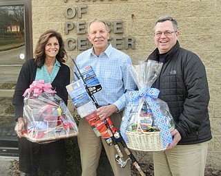 SPECIAL TO THE VINDICATOR
Prince of Peace Center’s annual bowl-a-thon fundraiser “Strike Out Poverty” will take place at noon March 5 at Thornton Hall Bowling Lanes, 1208 Hall Ave., Sharon, Pa. There will be a basket auction, 50-50 raffle and prizes. Teams of up to five bowlers must register by Monday to guarantee a free T-shirt and chance at various prizes. The cost is $30 per person and includes three games, shoe rental and food and drink tickets. To register a team or individual or to be a sponsor, call 724-346-7777, ext. 14, or visit www.princeofpeacecenter.org/events/2017-bowlathon and download the registration form. Return the completed form to the center at 502 Darr Ave., Farrell, Pa. 16121. Sponsors are needed at five levels: gold, silver, bronze, friend and donation. The benefit will support life skills classes and family supportive services programs. Preparing event prizes, from left, are Natalie Higbee, director of Family Support Services; Joe Flecher, executive director of POPC; and Joseph Walsh, president of O’Neill Coffee Co., a corporate sponsor.
