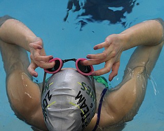 Gia Direnzo readjusters her swim goggles during practice at Beeghly Natatorium at YSU in Youngstown on Tuesday, Feb. 14, 2017. ..(Nikos Frazier | The Vindicator)..