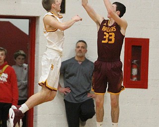 Anthony Ritter(33) of South Range goes up for three as Pat Pelini(10) of Mooney tries to block his shot during the first quarter as South Range High School takes on Cardinal Mooney High School at the Cardinal Mooney High School Gymnasium in Youngstown on Tuesday, Feb. 14, 2017.  South Range won 65-43..(Nikos Frazier | The Vindicator)..