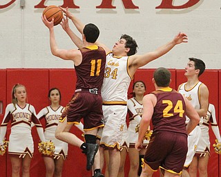 Dan Ritter(11) of South Range charges towards the basket as Vinny Gentile(34) of Mooney tries to block the ball's shot during the first quarter as South Range High School takes on Cardinal Mooney High School at the Cardinal Mooney High School Gymnasium in Youngstown on Tuesday, Feb. 14, 2017. South Range won 65-43..(Nikos Frazier | The Vindicator)..