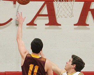 Dan Ritter(11) of South Range charges towards the basket as Vinny Gentile(34) of Mooney tries to block the ball's shot during the first quarter as South Range High School takes on Cardinal Mooney High School at the Cardinal Mooney High School Gymnasium in Youngstown on Tuesday, Feb. 14, 2017.  South Range won 65-43..(Nikos Frazier | The Vindicator)..