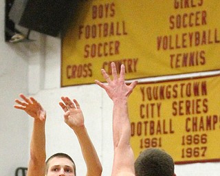 Pat Pelini(10) of Mooney goes up for three as Taymer Graham(24) of South Range tries to block the shot during the first quarter as South Range High School takes on Cardinal Mooney High School at the Cardinal Mooney High School Gymnasium in Youngstown on Tuesday, Feb. 14, 2017.  South Range won 65-43..(Nikos Frazier | The Vindicator)..