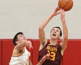 Anthony Ritter(33) of South Range and Anthony Fire(11) of Mooney fight for the rebound during the third quarter as South Range High School takes on Cardinal Mooney High School at the Cardinal Mooney High School Gymnasium in Youngstown on Tuesday, Feb. 14, 2017.  South Range won 65-43..(Nikos Frazier | The Vindicator)..
