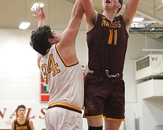 Dan Ritter(11) of South Range jumps up for two as Vinny Gentile(34) of Mooney tries to block the shot during the fourth quarter as South Range High School takes on Cardinal Mooney High School at the Cardinal Mooney High School Gymnasium in Youngstown on Tuesday, Feb. 14, 2017.  South Range won 65-43..(Nikos Frazier | The Vindicator)..
