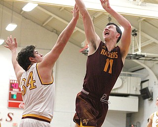 Dan Ritter(11) of South Range jumps up for two as Vinny Gentile(34) of Mooney tries to block the shot during the fourth quarter as South Range High School takes on Cardinal Mooney High School at the Cardinal Mooney High School Gymnasium in Youngstown on Tuesday, Feb. 14, 2017.  South Range won 65-43..(Nikos Frazier | The Vindicator)..